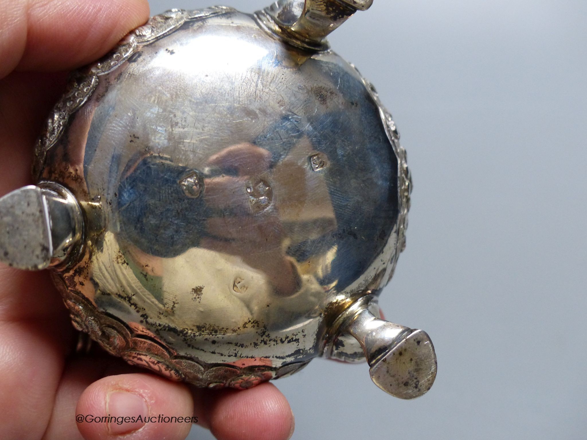 A pair of Georgian embossed silver cauldron salts, marks indistinct, 5oz. gross, 7.5 cm wide, One later blue glass liner